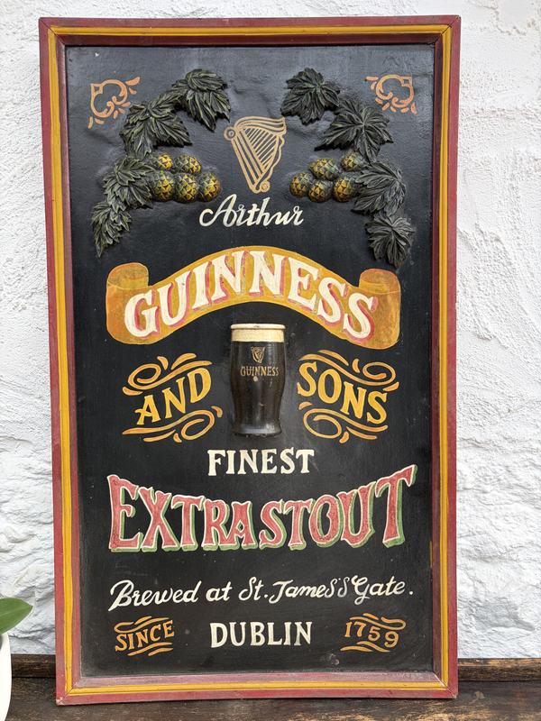A hand-painted vintage Arthur Guinness and Sons Extra Stout sign