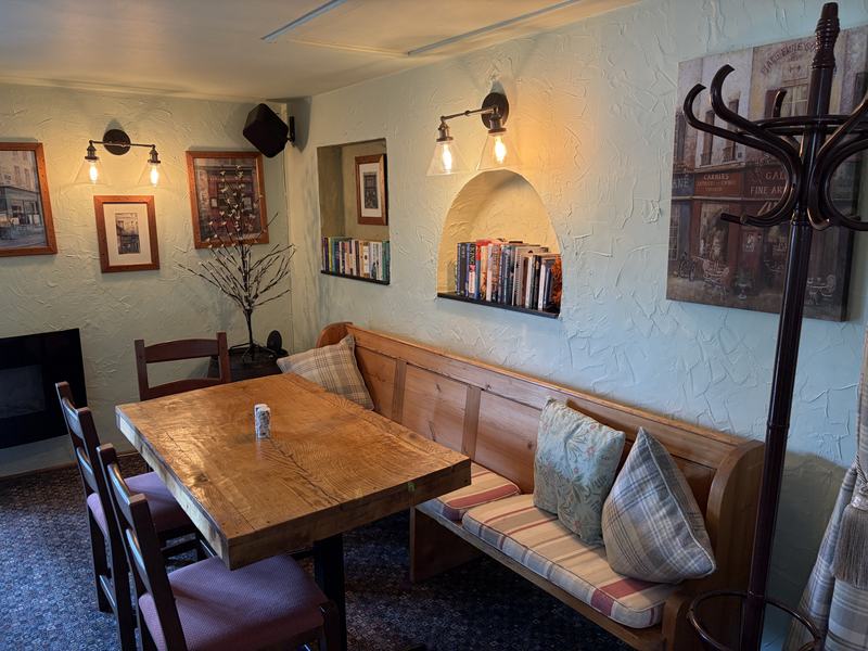 Oak tables and a cushioned bench in the dining room