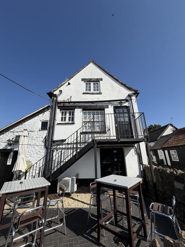 The rear of the inn with its outside staircase and balcony