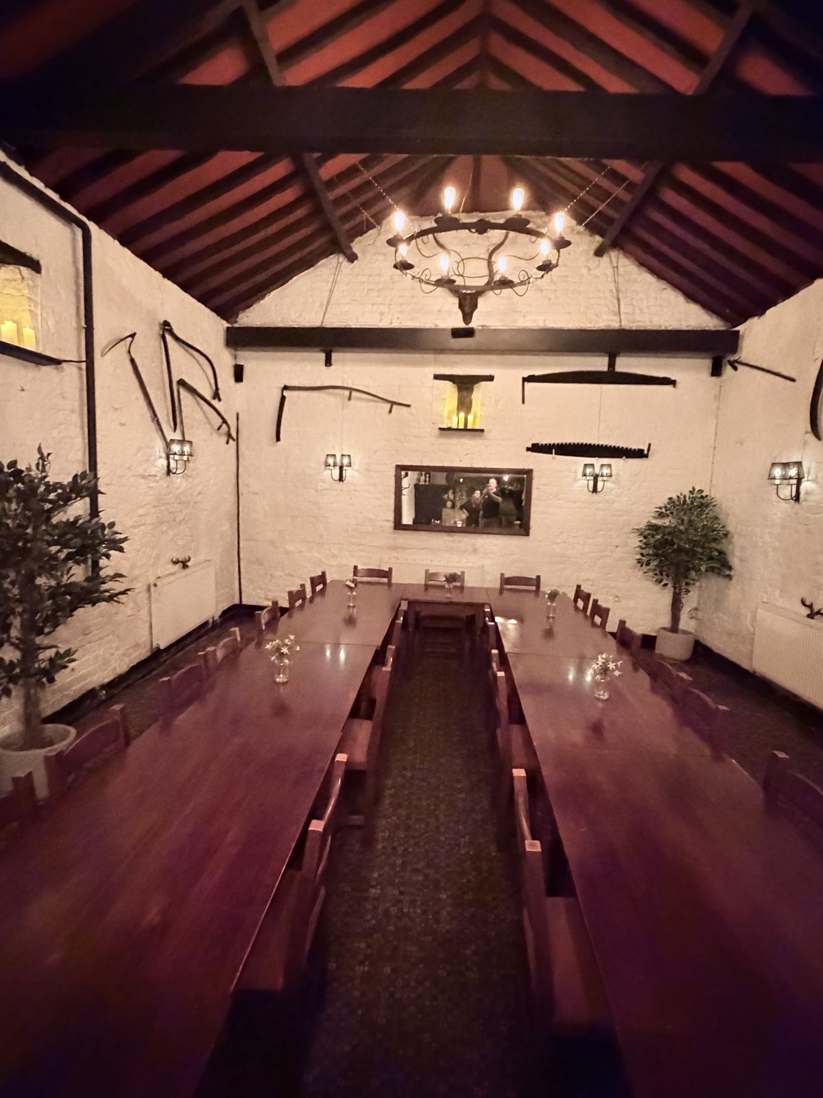 Long tables set with flowers and candles running the length of the function room